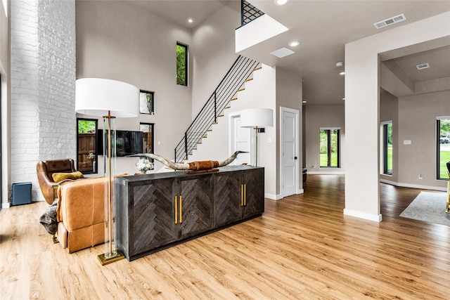 2856 Peninsula Dr, Grapevine, TX 76051 - living area with visible vents, a high ceiling, light wood-style flooring, and a wealth of natural light