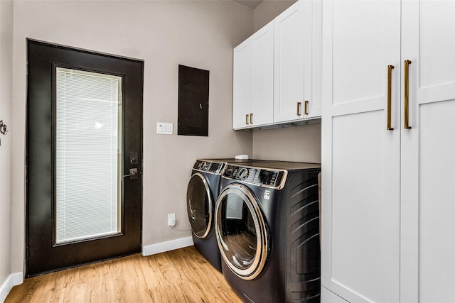 2856 Peninsula Dr, Grapevine, TX 76051 - laundry room featuring baseboards, washer and clothes dryer, light wood-style flooring, electric panel, and cabinet space