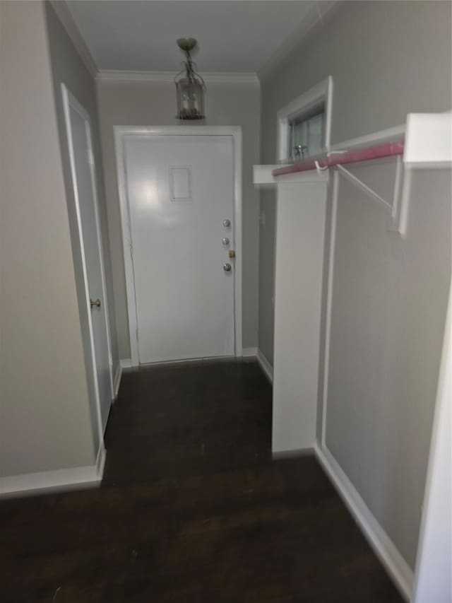 corridor featuring crown molding, dark wood-style flooring, and baseboards