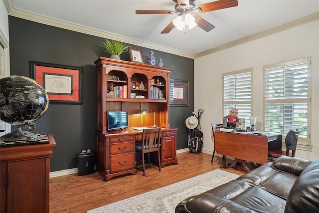 home office featuring light wood-style floors, baseboards, crown molding, and a ceiling fan
