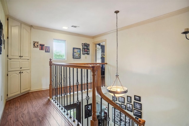 corridor featuring crown molding, baseboards, wood finished floors, and an upstairs landing