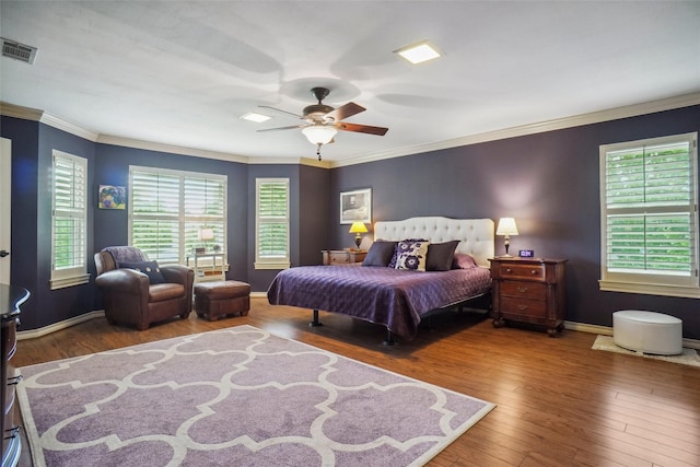 bedroom featuring visible vents, a ceiling fan, crown molding, and wood finished floors