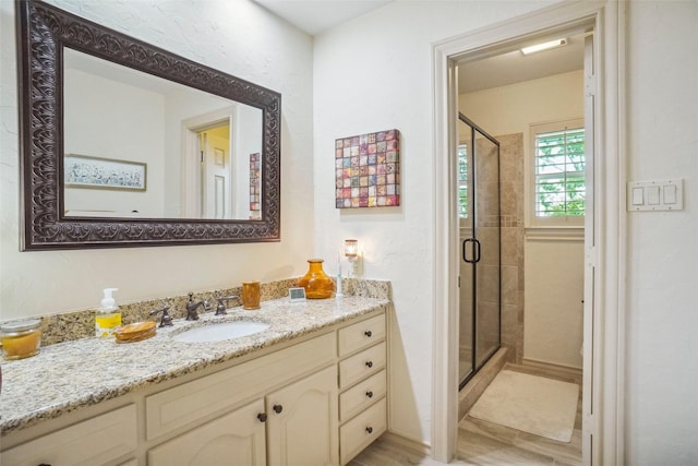 bathroom with vanity and a shower stall