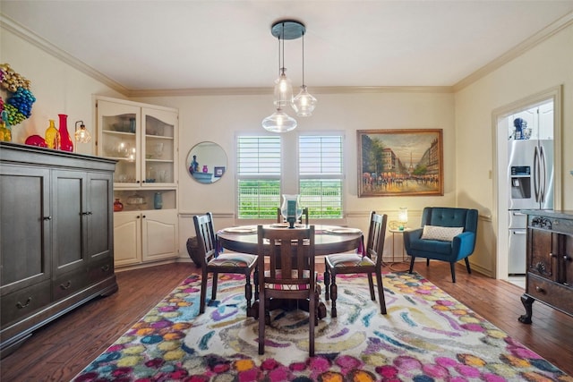 dining room featuring crown molding and dark wood-type flooring