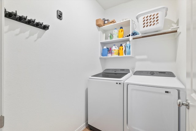 washroom with independent washer and dryer and laundry area