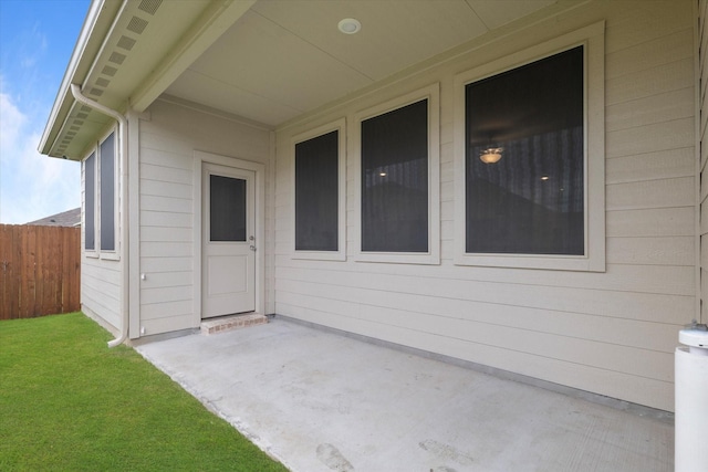 entrance to property with fence and a patio