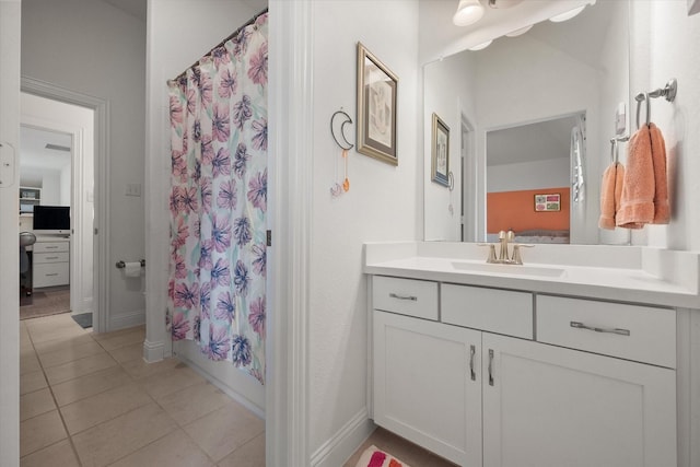 full bath with vanity, tile patterned flooring, baseboards, and shower / bath combo with shower curtain