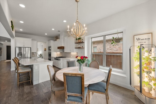 dining area with recessed lighting, baseboards, a notable chandelier, and dark wood-type flooring