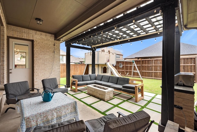 view of patio / terrace featuring a fenced backyard, an outdoor living space with a fire pit, and a pergola