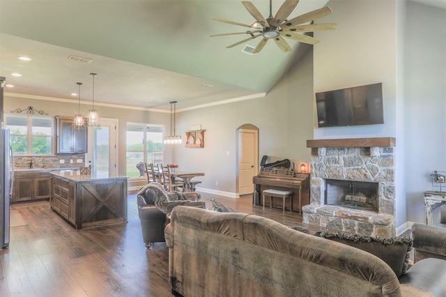 250 Beulah Rd, Millsap, TX 76066 - living area featuring plenty of natural light, arched walkways, dark wood finished floors, and ceiling fan