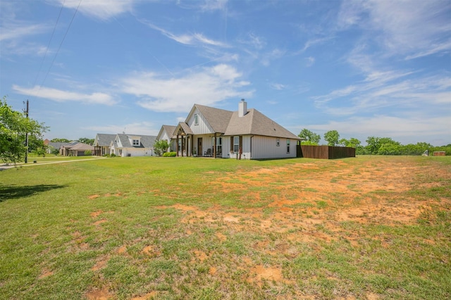 250 Beulah Rd, Millsap, TX 76066 - rear view of house featuring board and batten siding, a yard, and a chimney