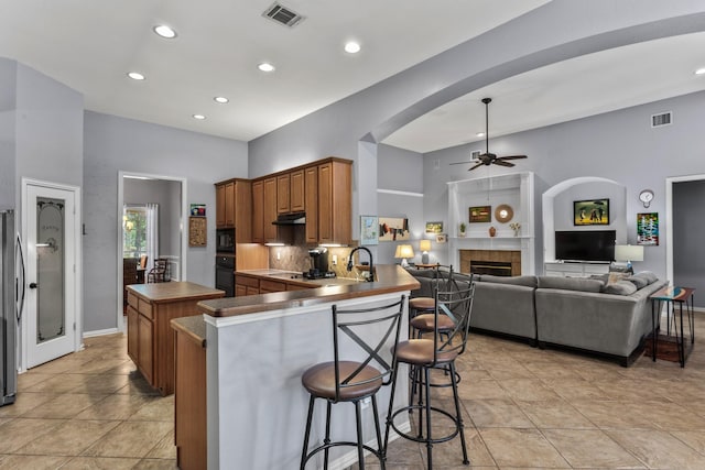 kitchen featuring ceiling fan, black appliances, visible vents, and under cabinet range hood