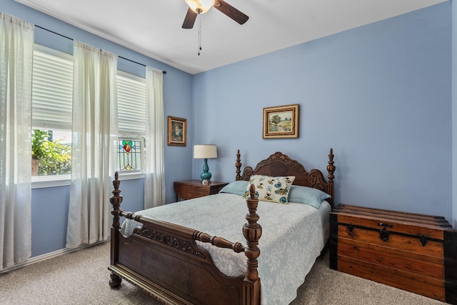 carpeted bedroom with a ceiling fan and baseboards