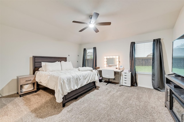 bedroom featuring baseboards, a ceiling fan, carpet, and multiple windows