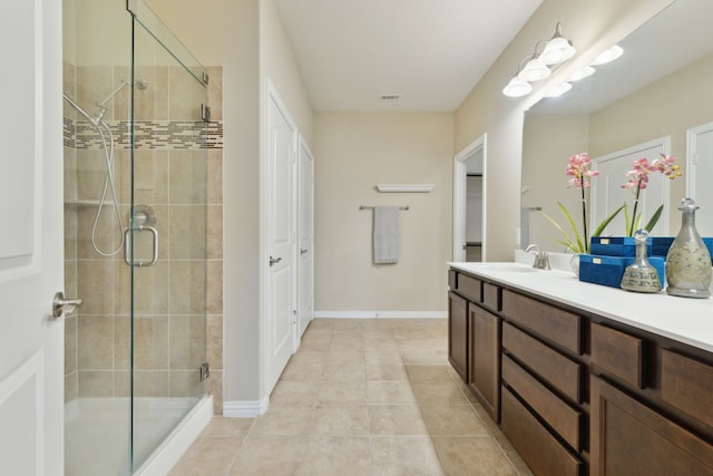 6281 Paragon Dr, Frisco, TX 75036 - bathroom with vanity, tile patterned floors, baseboards, visible vents, and a stall shower