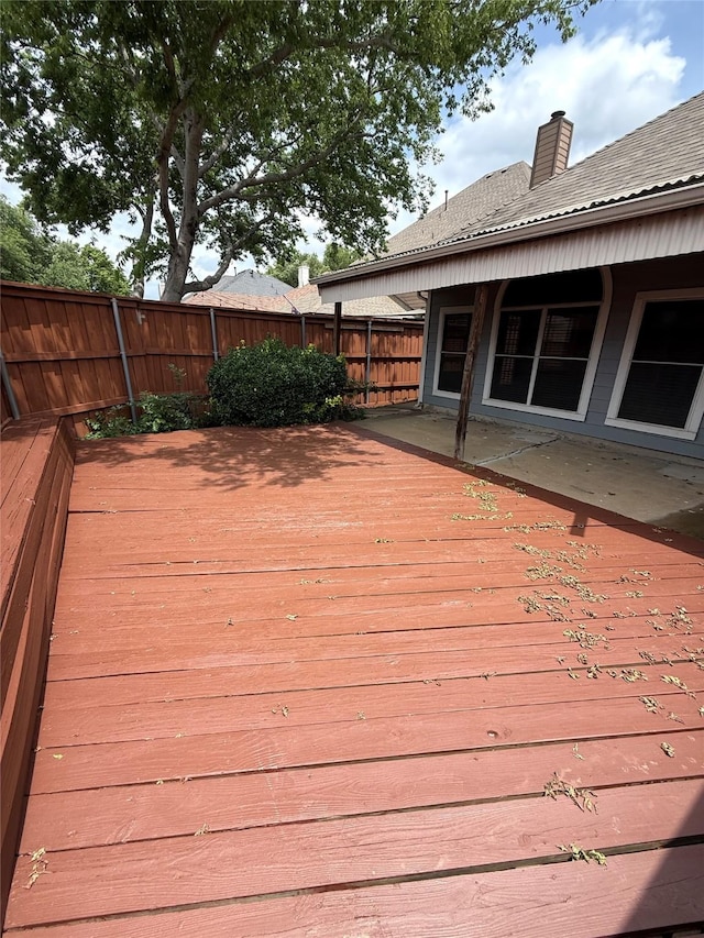 wooden terrace featuring fence