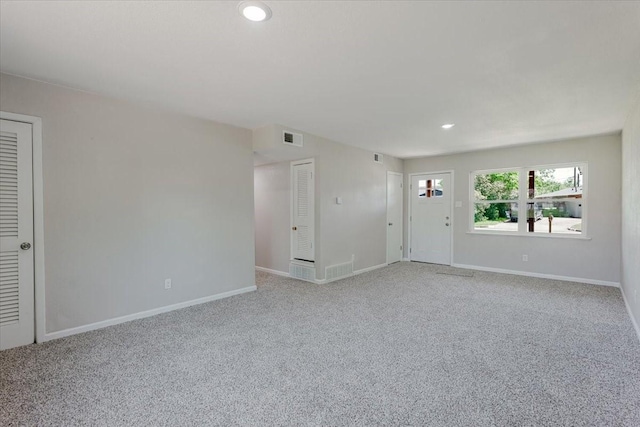 1017 SE 21st St, Mineral Wells, TX 76067 - unfurnished living room with baseboards, light colored carpet, recessed lighting, and visible vents