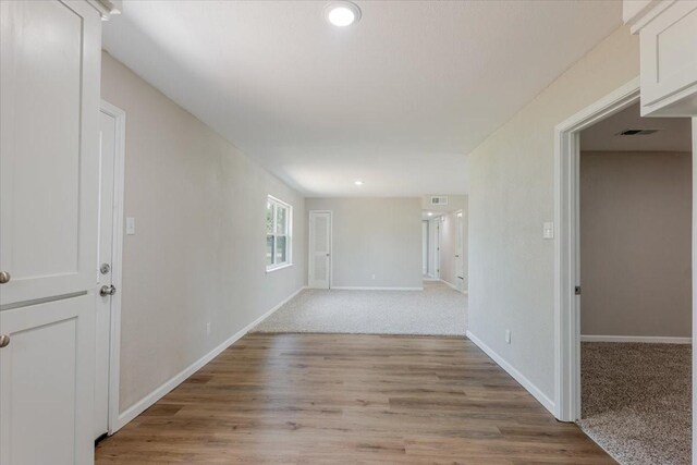 1017 SE 21st St, Mineral Wells, TX 76067 - empty room with baseboards, recessed lighting, light wood-style flooring, and visible vents