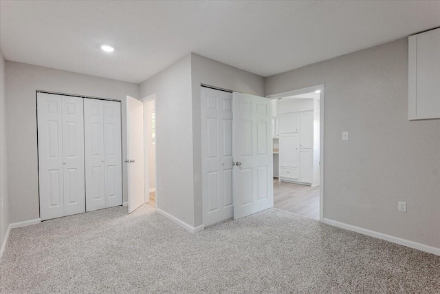 1017 SE 21st St, Mineral Wells, TX 76067 - unfurnished bedroom featuring baseboards, two closets, recessed lighting, and light colored carpet