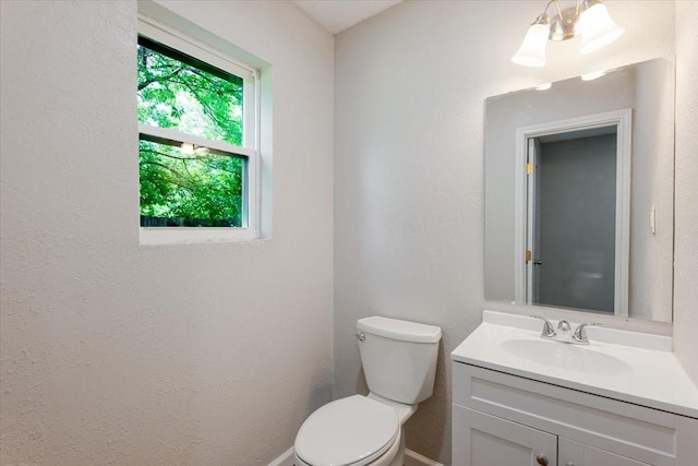 1017 SE 21st St, Mineral Wells, TX 76067 - bathroom featuring toilet, baseboards, and vanity