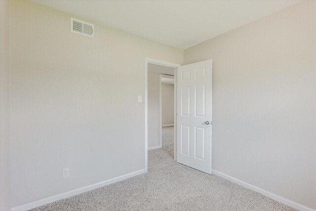 1017 SE 21st St, Mineral Wells, TX 76067 - carpeted spare room featuring baseboards and visible vents