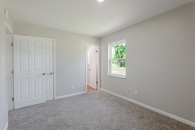 1017 SE 21st St, Mineral Wells, TX 76067 - unfurnished bedroom featuring baseboards, carpet flooring, and visible vents