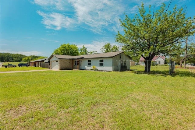 1017 SE 21st St, Mineral Wells, TX 76067 - view of front of home featuring concrete driveway, an attached garage, fence, and a front lawn