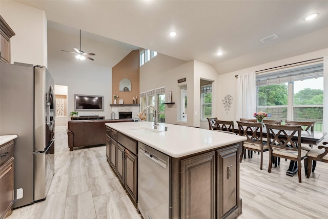 749 Copperleaf Dr, Midlothian, TX 76065 - kitchen with stainless steel appliances, a kitchen island with sink, a breakfast bar area, a ceiling fan, and premium range hood