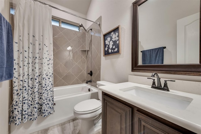 bathroom featuring toilet, shower / bath combo with shower curtain, and vanity