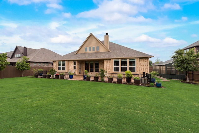 rear view of house with brick siding, a chimney, a patio area, and a shingled roof