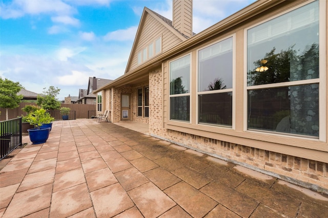 749 Copperleaf Dr, Midlothian, TX 76065 - rear view of house with brick siding, a chimney, a patio area, and a shingled roof