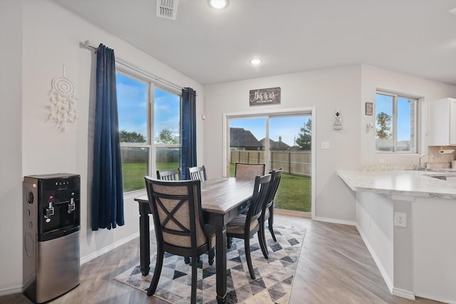 dining space with light wood-style floors, recessed lighting, baseboards, and visible vents