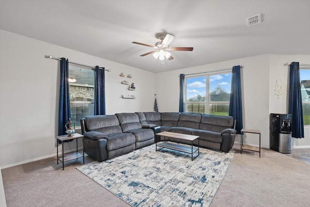 carpeted living room with a ceiling fan, baseboards, and visible vents