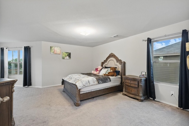 bedroom featuring light colored carpet, baseboards, and visible vents