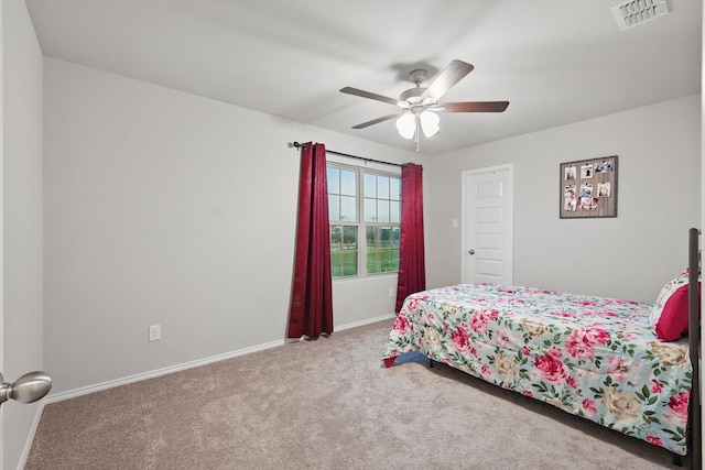 carpeted bedroom featuring a ceiling fan, baseboards, and visible vents
