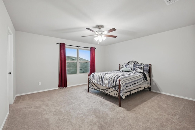 bedroom featuring carpet flooring, baseboards, visible vents, and ceiling fan