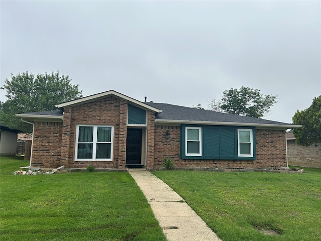 single story home featuring brick siding and a front lawn