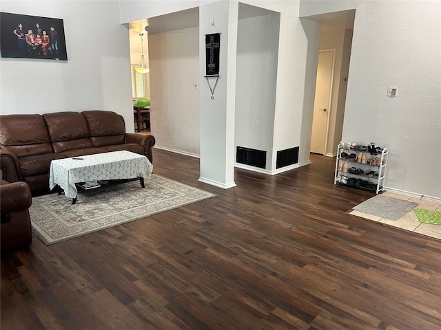 living room with baseboards and wood finished floors