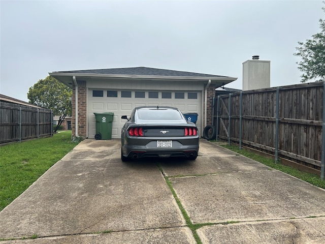garage with fence and driveway