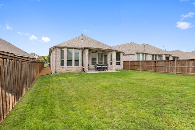 1732 Journey Forth Trl, Wylie, TX 75098 - rear view of house featuring a yard, brick siding, a fenced backyard, and a patio area