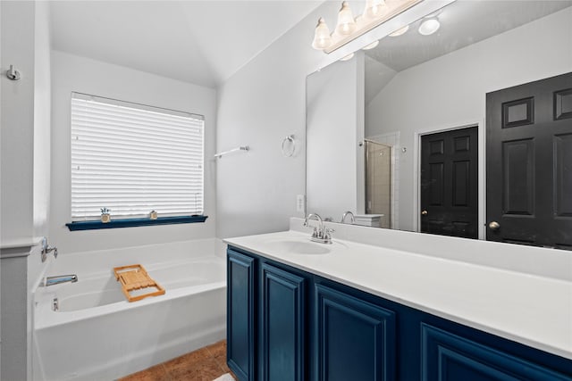 bathroom featuring a shower with shower door, a bath, tile patterned flooring, lofted ceiling, and vanity