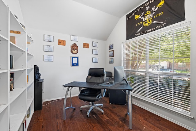 office space with lofted ceiling, baseboards, and wood finished floors