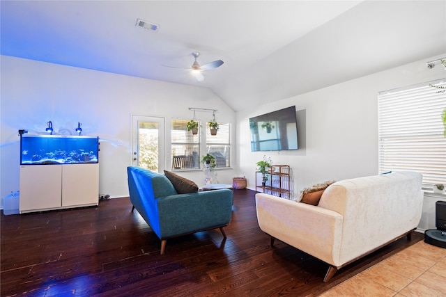living area with lofted ceiling, a ceiling fan, visible vents, and wood finished floors