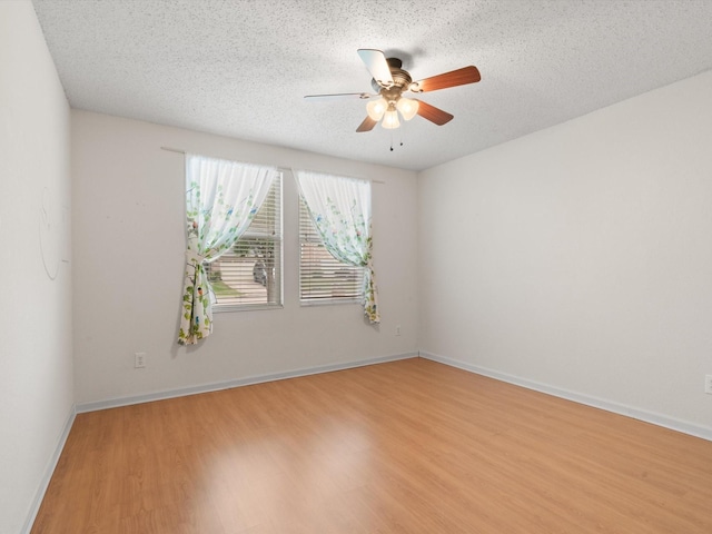 1728 Creek Bend Ln, Little Elm, TX 75068 - unfurnished room with a ceiling fan, a textured ceiling, baseboards, and light wood finished floors