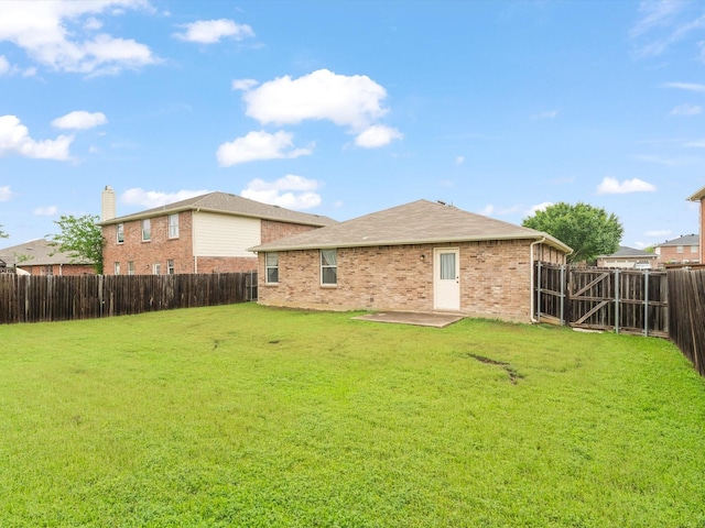 1728 Creek Bend Ln, Little Elm, TX 75068 - rear view of house featuring a fenced backyard, a yard, a patio area, and brick siding