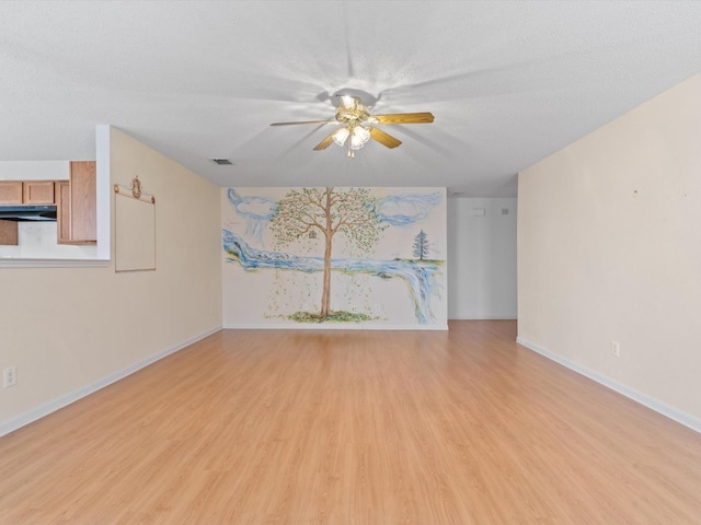 1728 Creek Bend Ln, Little Elm, TX 75068 - unfurnished living room with ceiling fan, a textured ceiling, visible vents, baseboards, and light wood-style floors