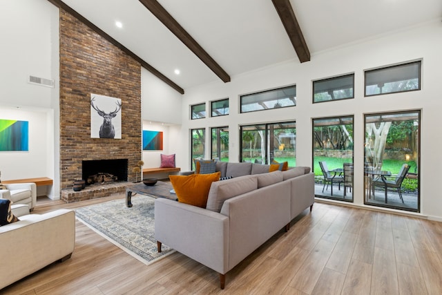 7509 Spring Meadow Ln, Garland, TX 75044 - living area with high vaulted ceiling, beam ceiling, light wood finished floors, a brick fireplace, and recessed lighting