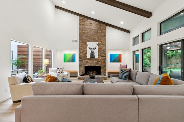 7509 Spring Meadow Ln, Garland, TX 75044 - living room with light wood-style flooring, high vaulted ceiling, beam ceiling, a fireplace, and recessed lighting