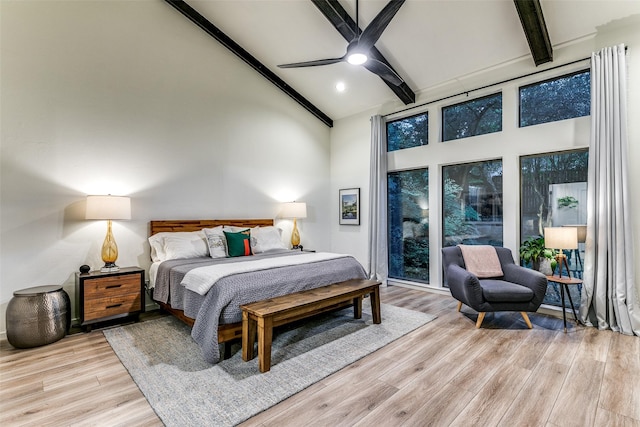 7509 Spring Meadow Ln, Garland, TX 75044 - bedroom with high vaulted ceiling, beamed ceiling, light wood-style flooring, and ceiling fan