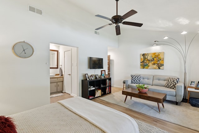 7509 Spring Meadow Ln, Garland, TX 75044 - bedroom with light wood-style floors, ensuite bathroom, and a high ceiling